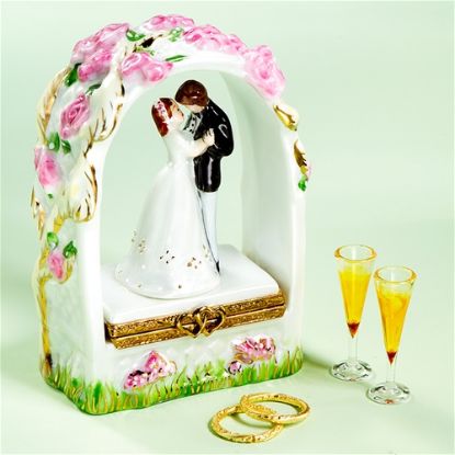 Picture of Limoges Wedding Couple under Arch Box with Champagne Glasses and Wedding Bands